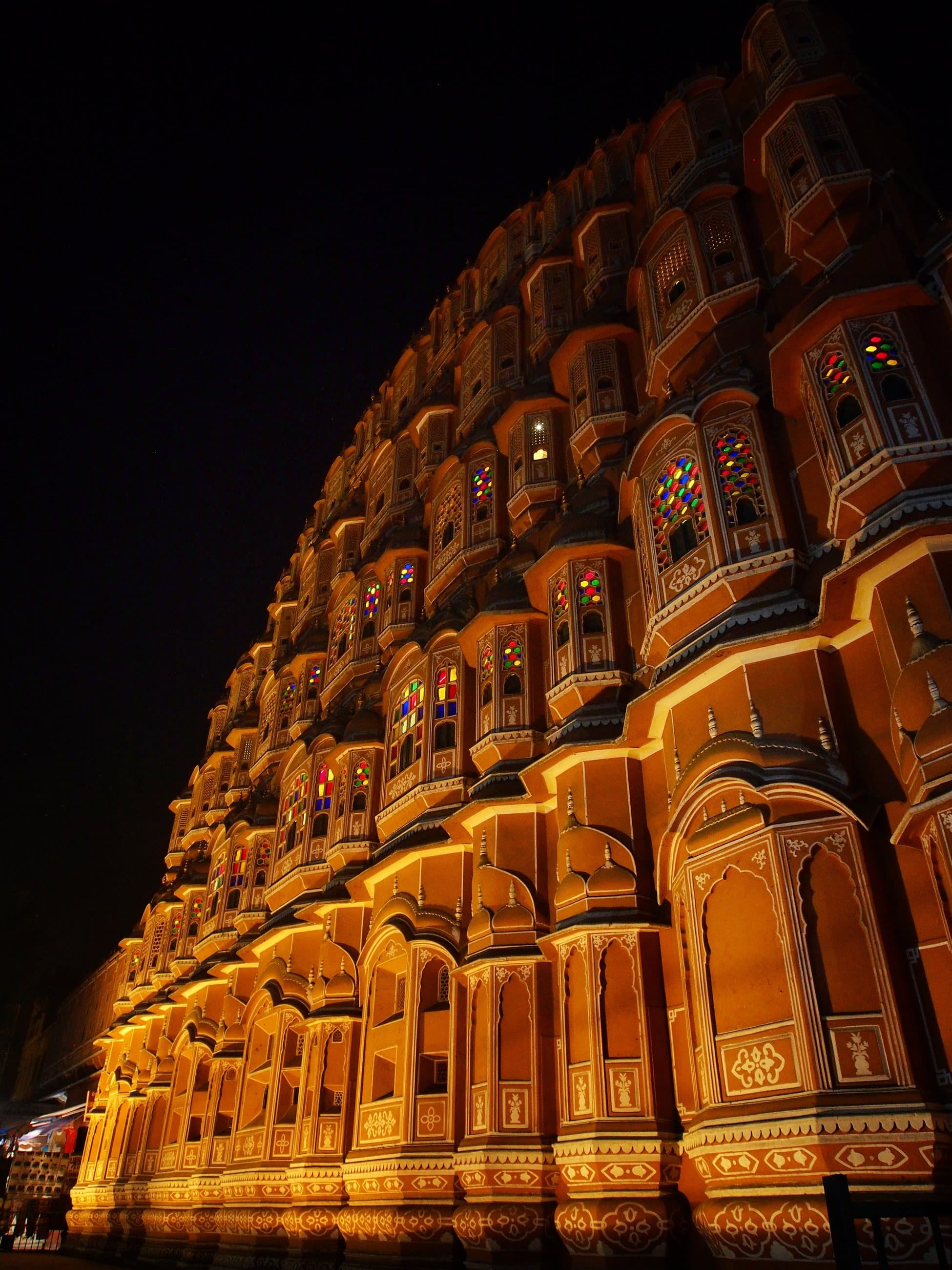 The honeycomb facade of the Hawa Mahal lit at night
