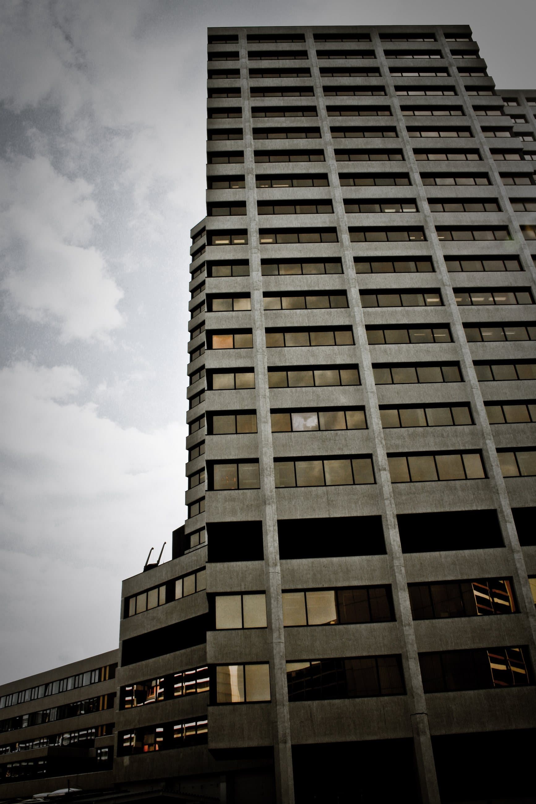 Concrete residential tower of the Ihme-Zentrum against a pale sky