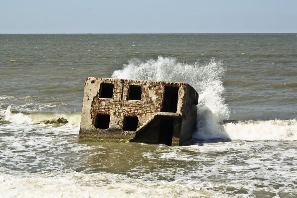 A broken concrete bunker in the surf of the Baltic Sea
